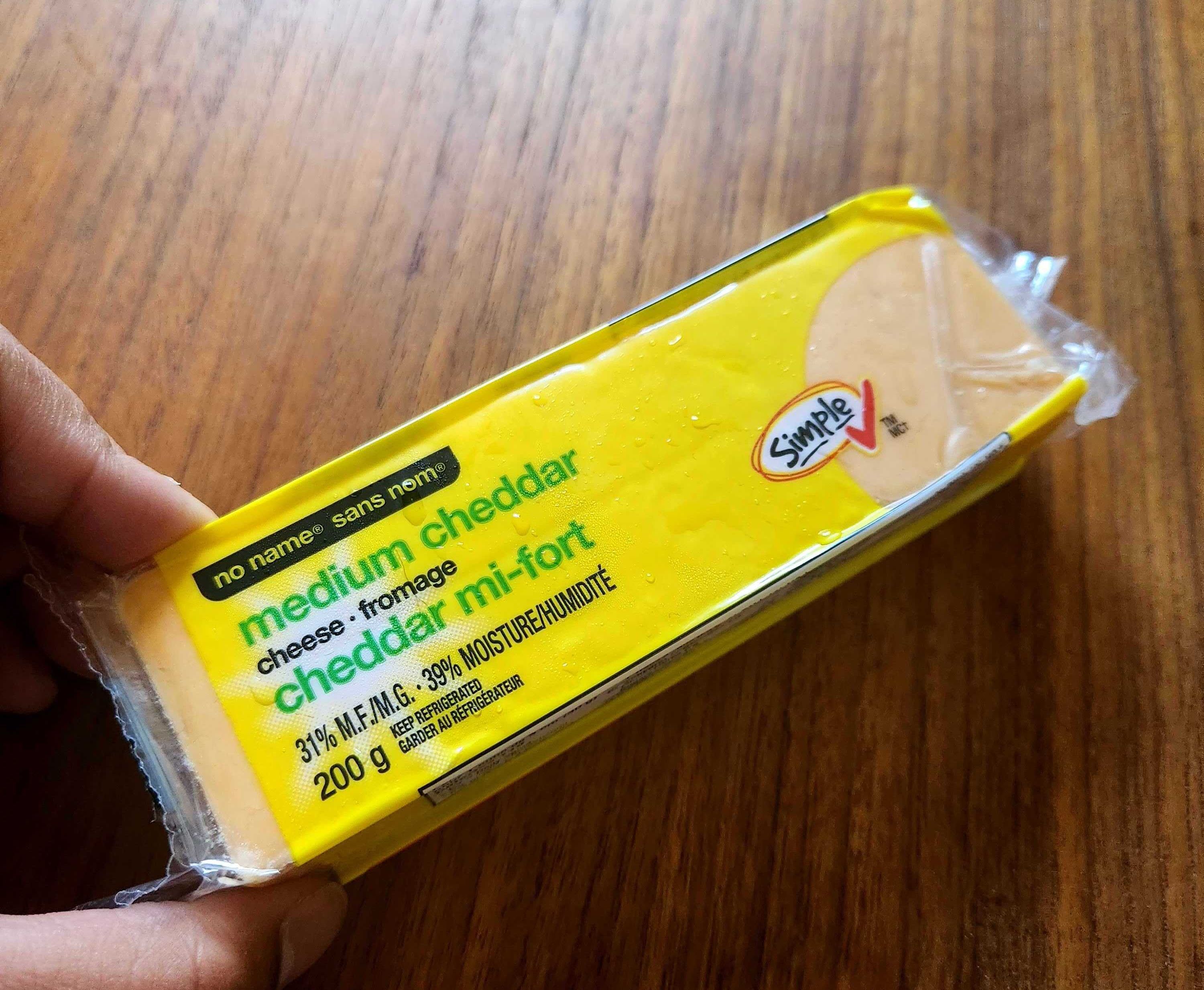 150 grams of No Name brand medium cheddar cheese from No Frills for $3.49.