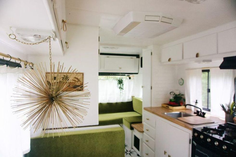 1970s camper stay with green velvet, This Ontario Campground Motel Is Off The Grid & Has Serious Woodstock Vibes