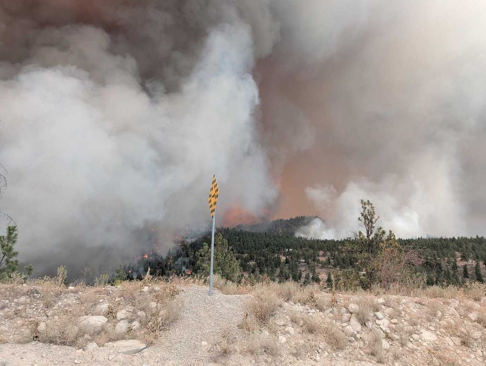 20,000 flee as explosive B.C. wildfire burns homes