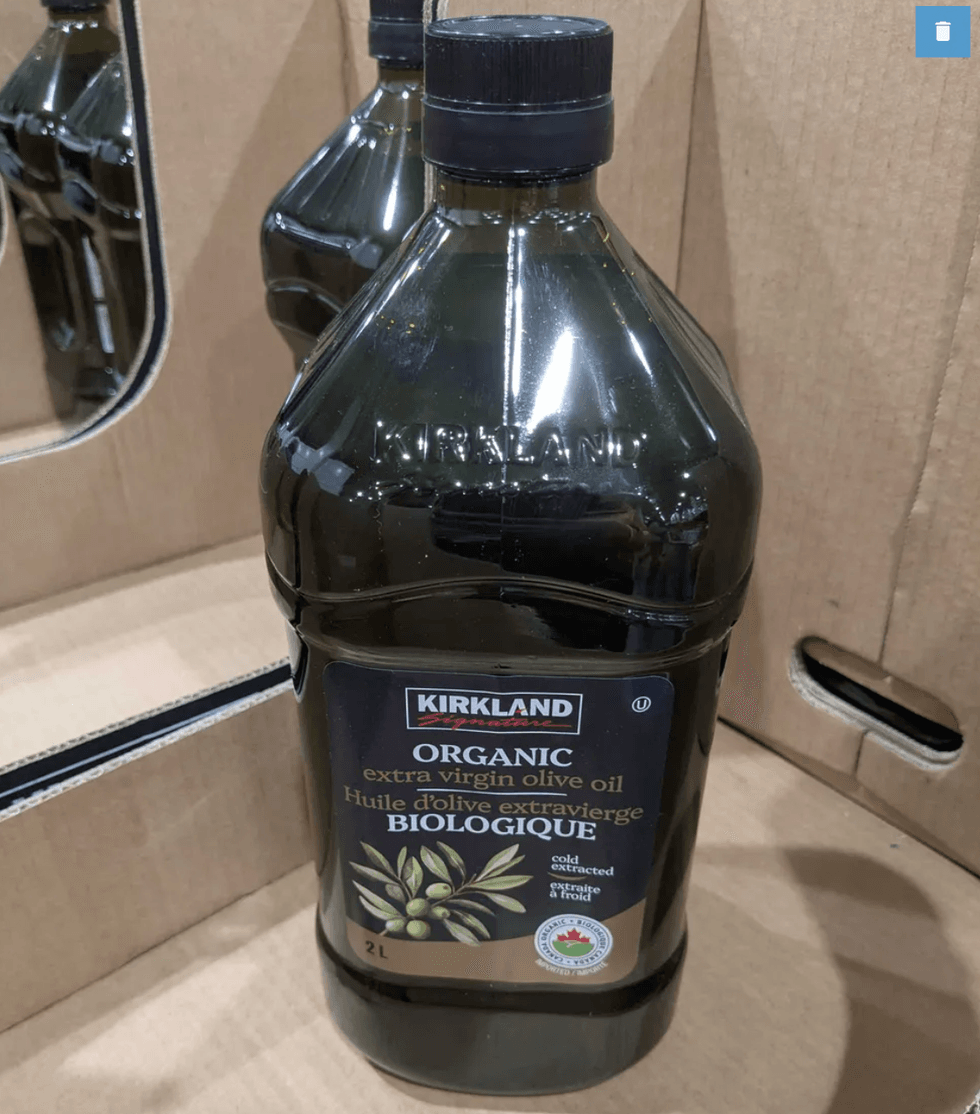 A 2L bottle of Kirkland organic extra virgin olive oil in a cardboard box.