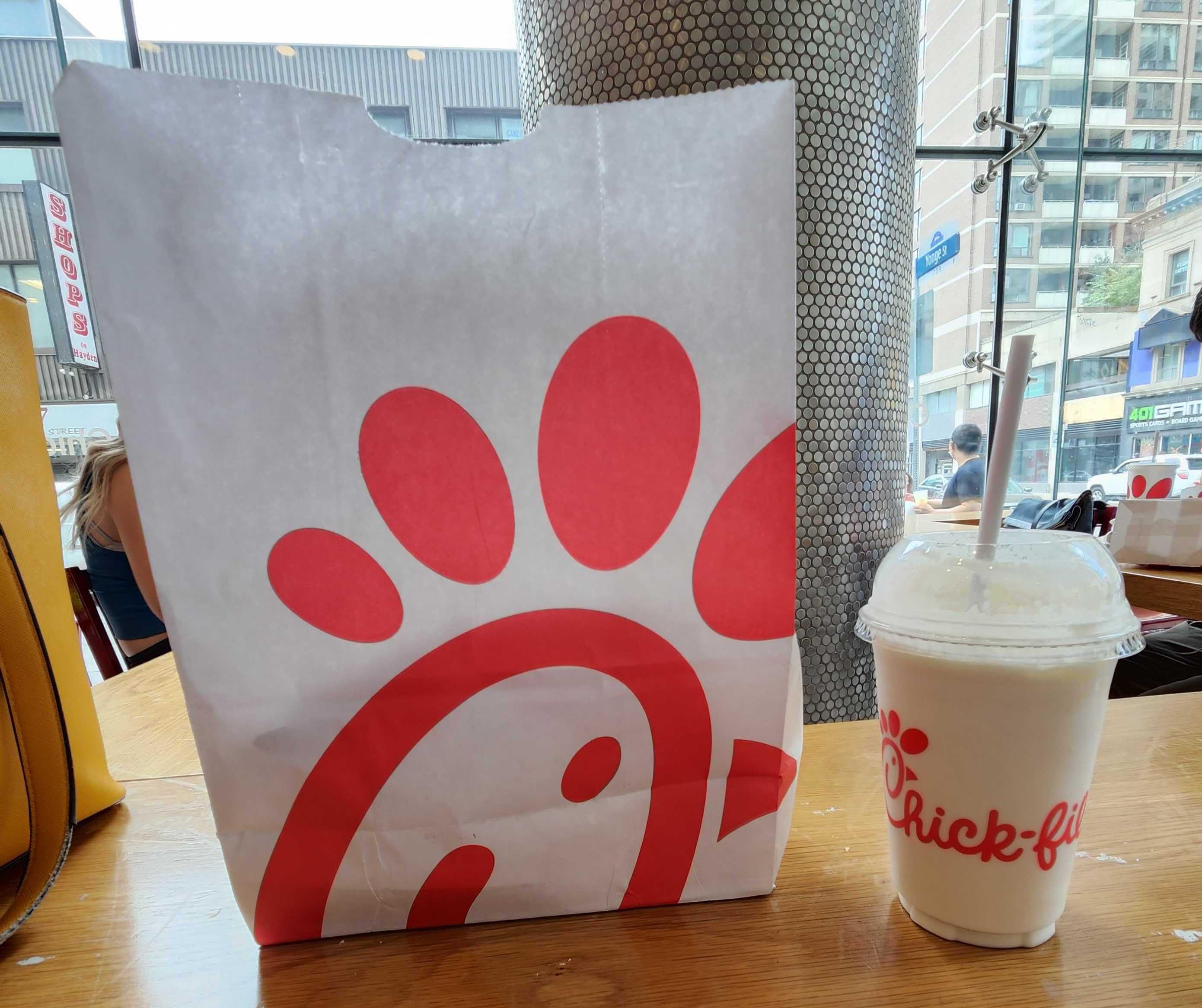 A bag of food and a drink at a Canadian Chick-fil-A.