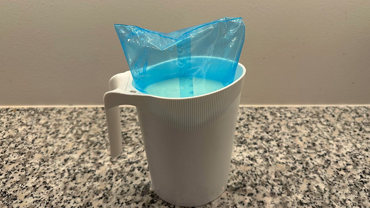 A bag of milk in a milk jug.