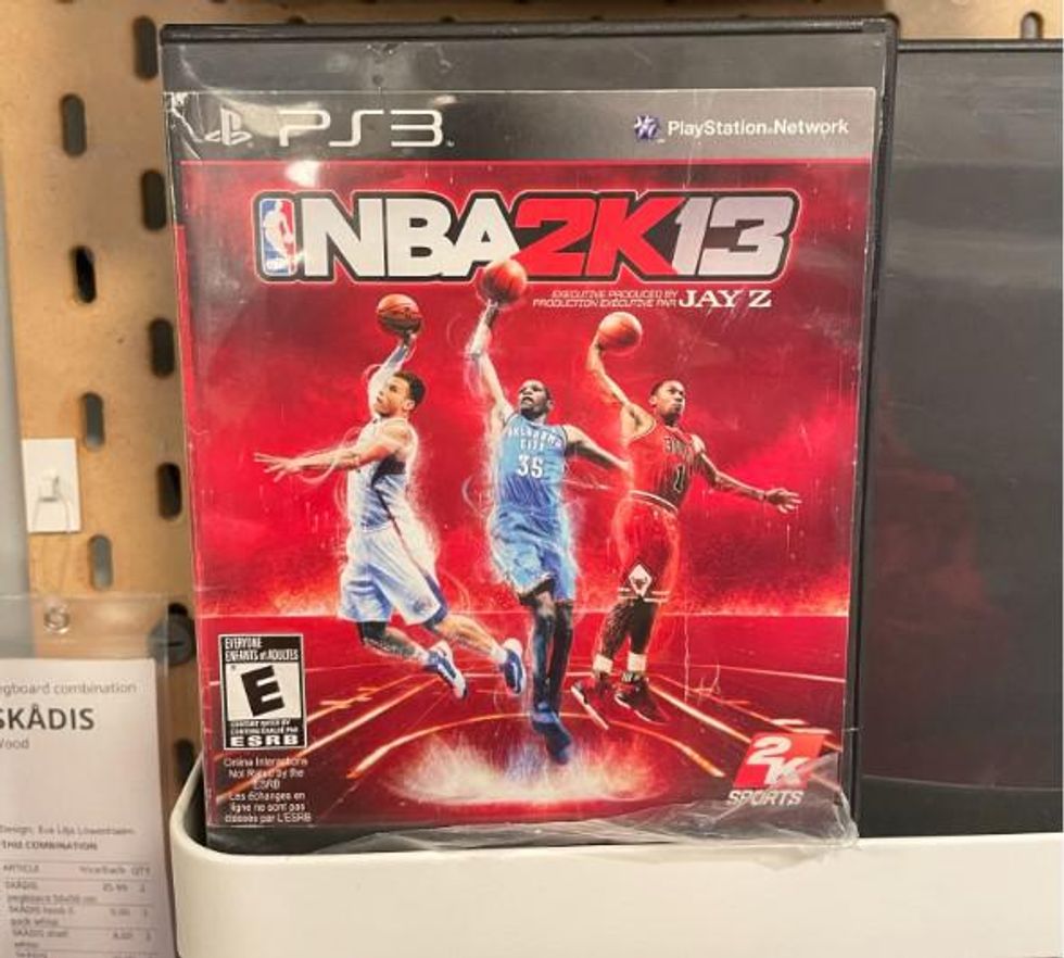 A beat up DVD case with the NBA 2K13 cover on it.