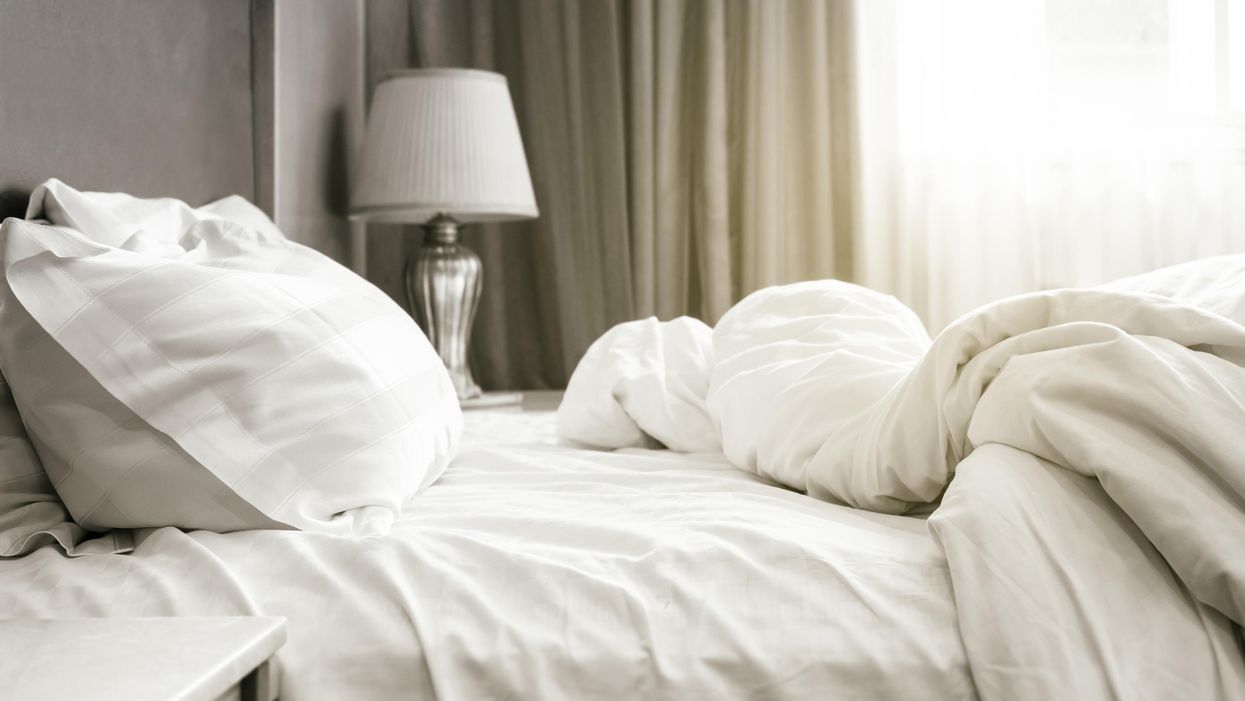 A bed with rumpled sheets.