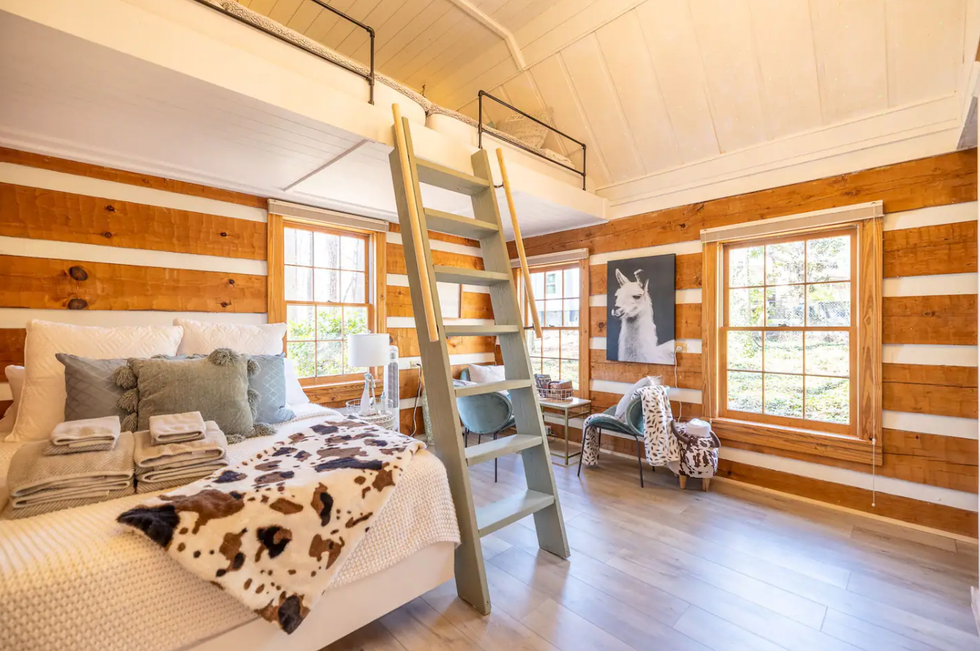 A bedroom and loft ladder at the Cottage of Lake Lanier.