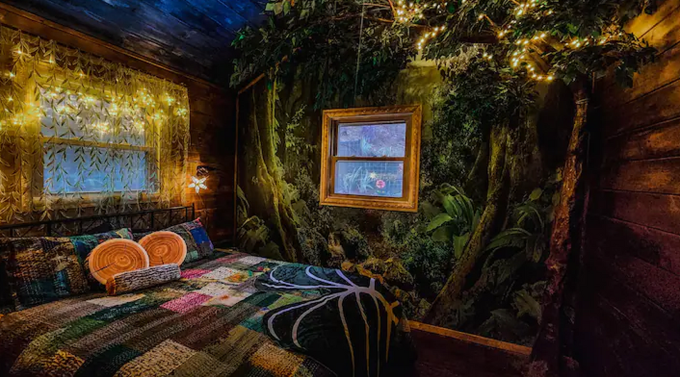 A bedroom inside the Mad Hatter Cottage in Blue Ridge, GA.