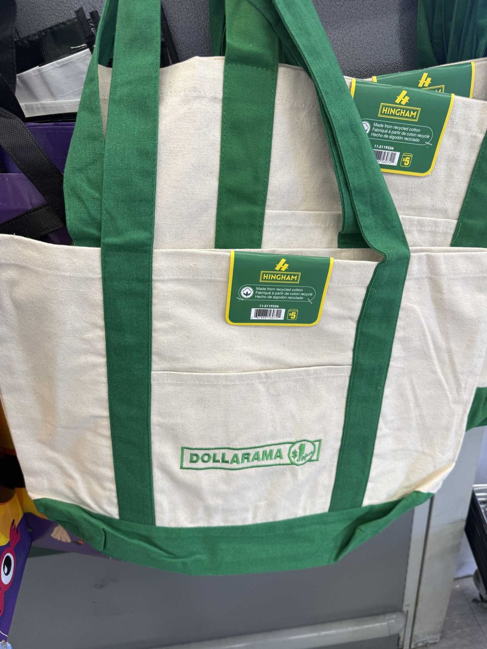 A beige and green tote bag that says Dollarama on it.