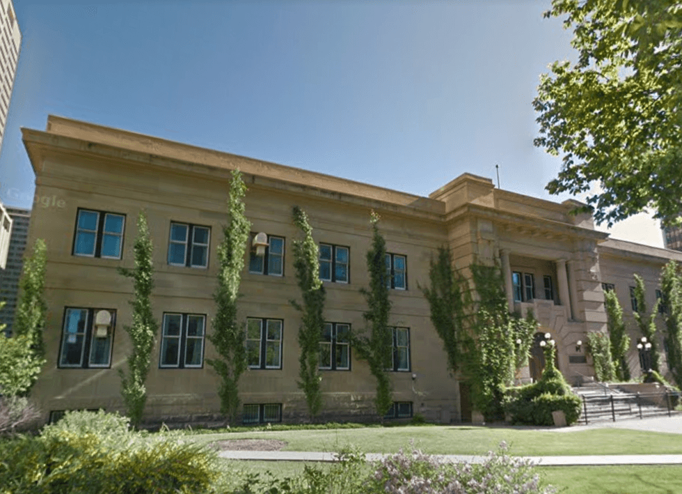 A beige building with trees.