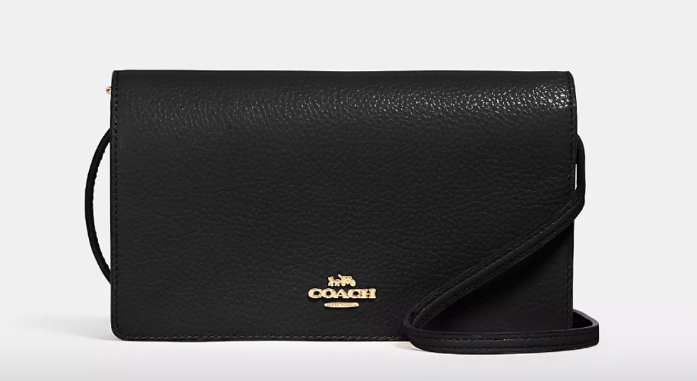 A black and gold purse from Coach.