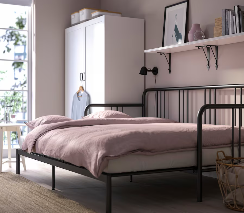 A black steel-framed daybed.