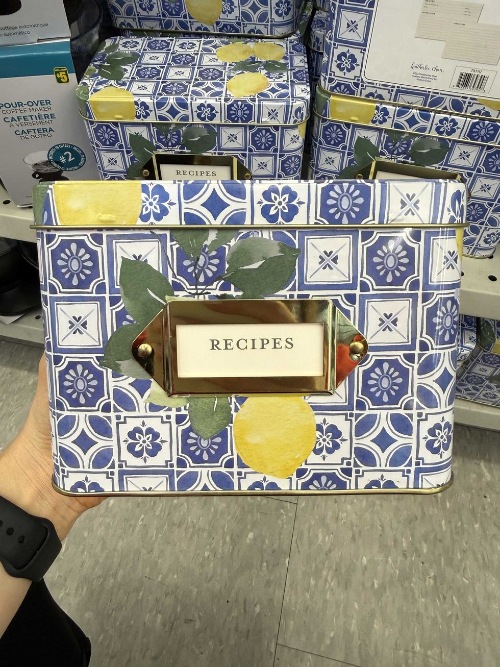 A blue and white recipe container with lemons on it.