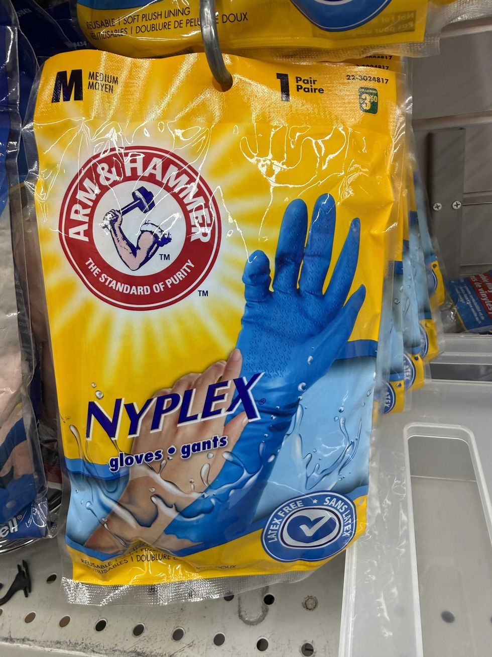 A blue and yellow bag with blue rubber gloves inside.
