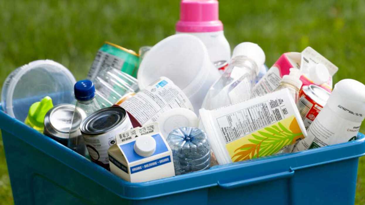 A blue box full of recyclable materials.