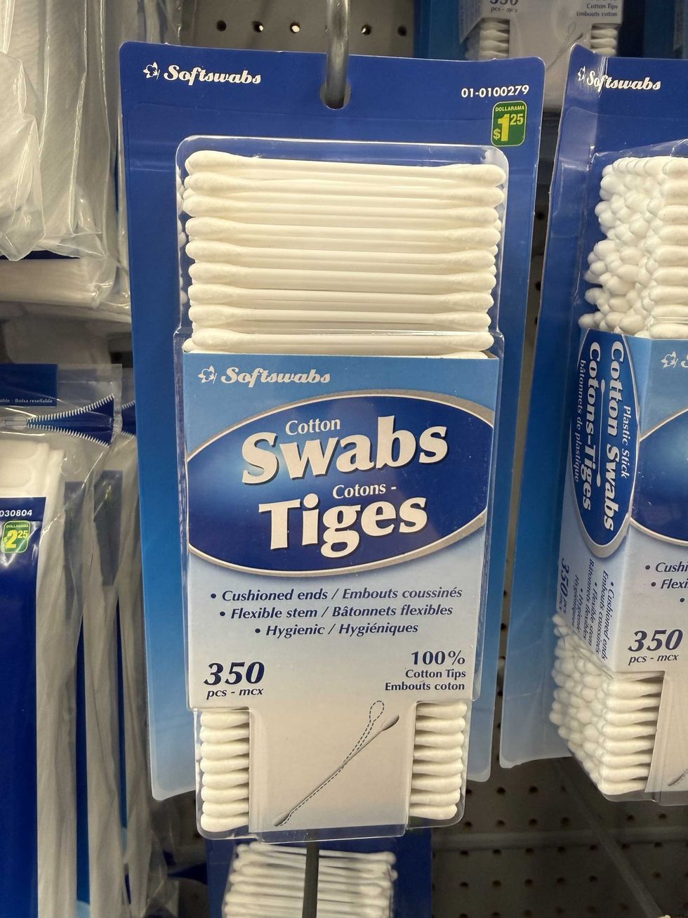 A blue box of cotton swabs hanging on a store shelf.
