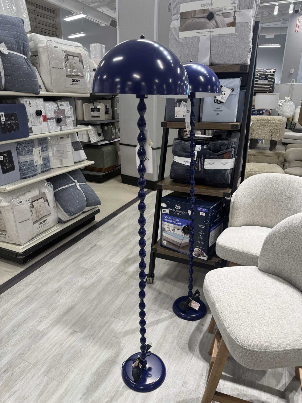 A blue floor lamp in a store.