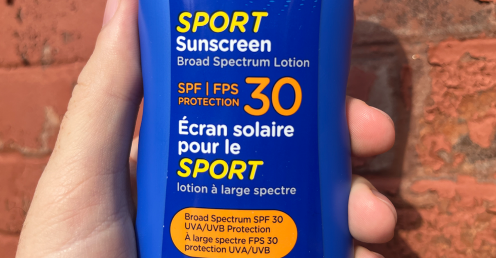 A bottle of sport sunscreen advertising "Broad Spectrum SPF 30 UVA/UVB Protection."