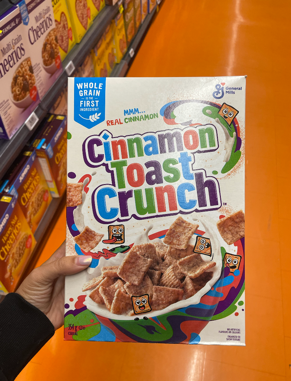A box Cinnamon Toast Crunch cereal at a grocery store.