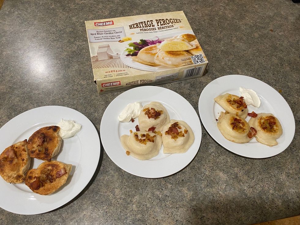 A box of CHEEMO Heritage Aged White Cheddar Cheese Perogies and three plates of cooked pierogi.