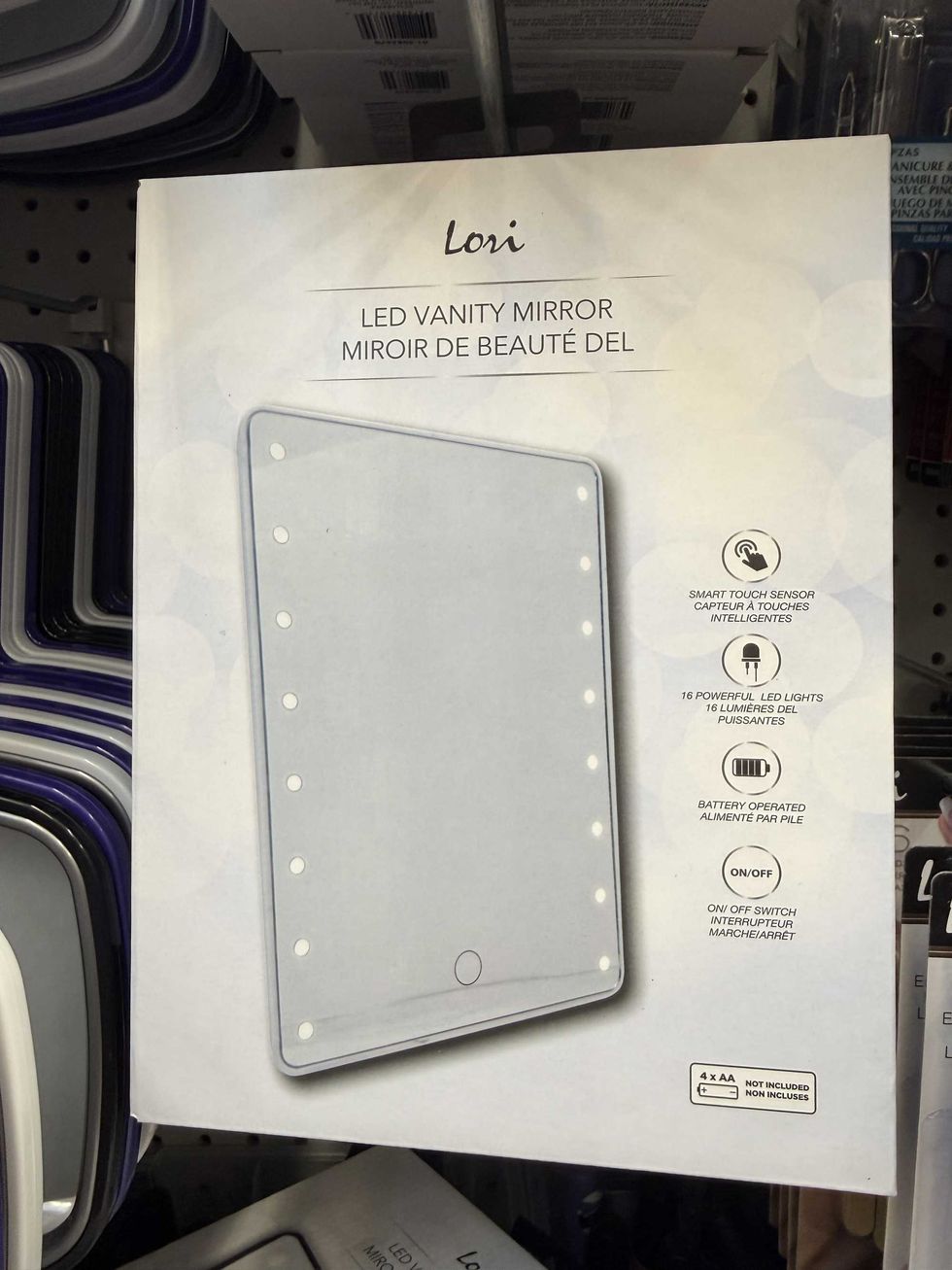 A box with a photo of a mirror and lights around it.