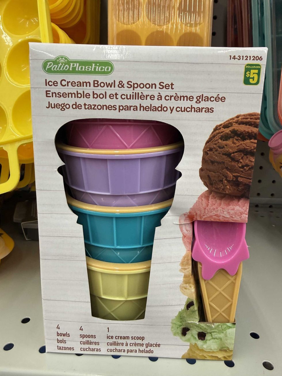 A box with colourful ice cream cone shaped bowls and matching spoons.