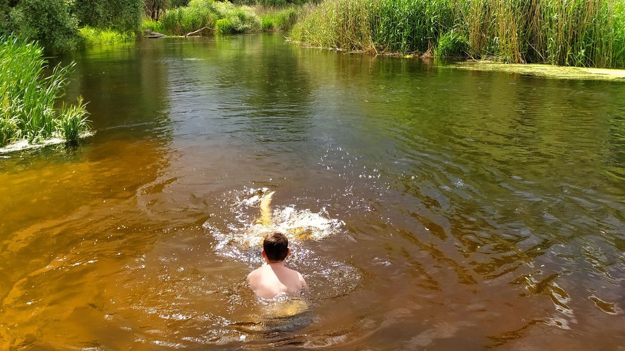 A boy in a river.