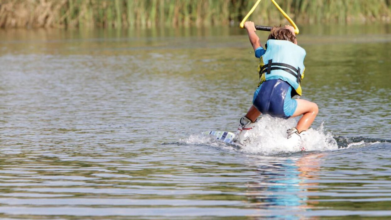A boy wakeboarding on Lake Mead.
