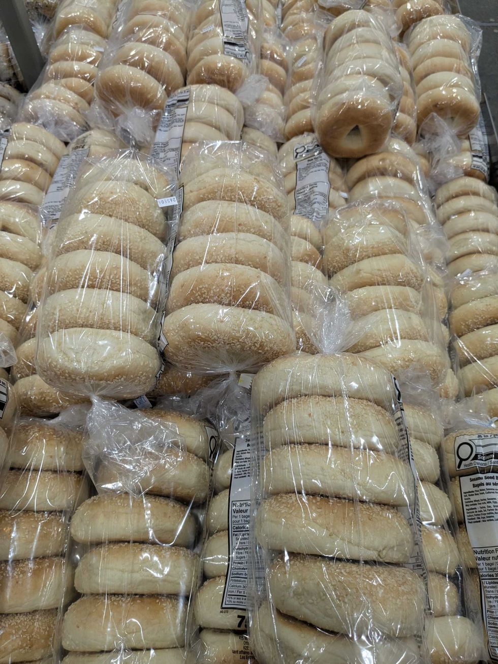 A bunch of packages of sesame bagels