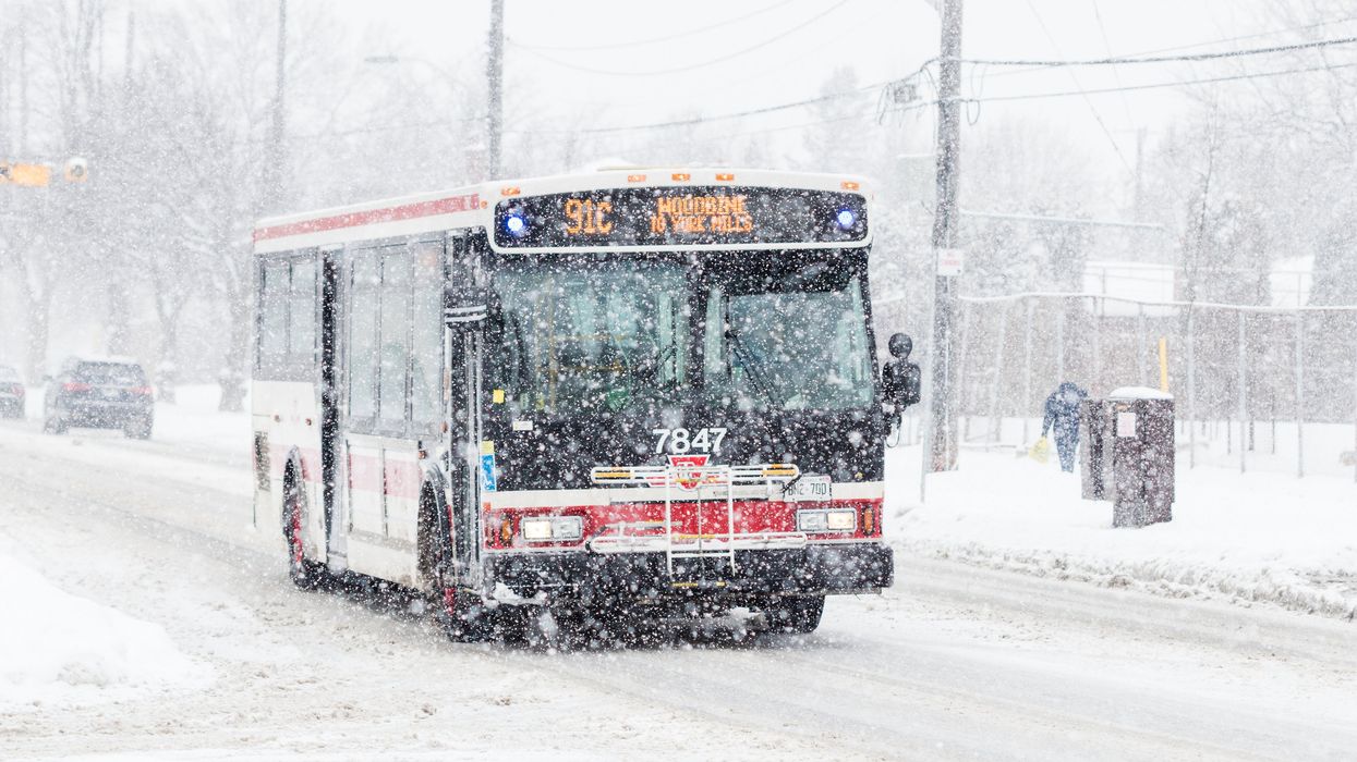 A bus driving in the snow.