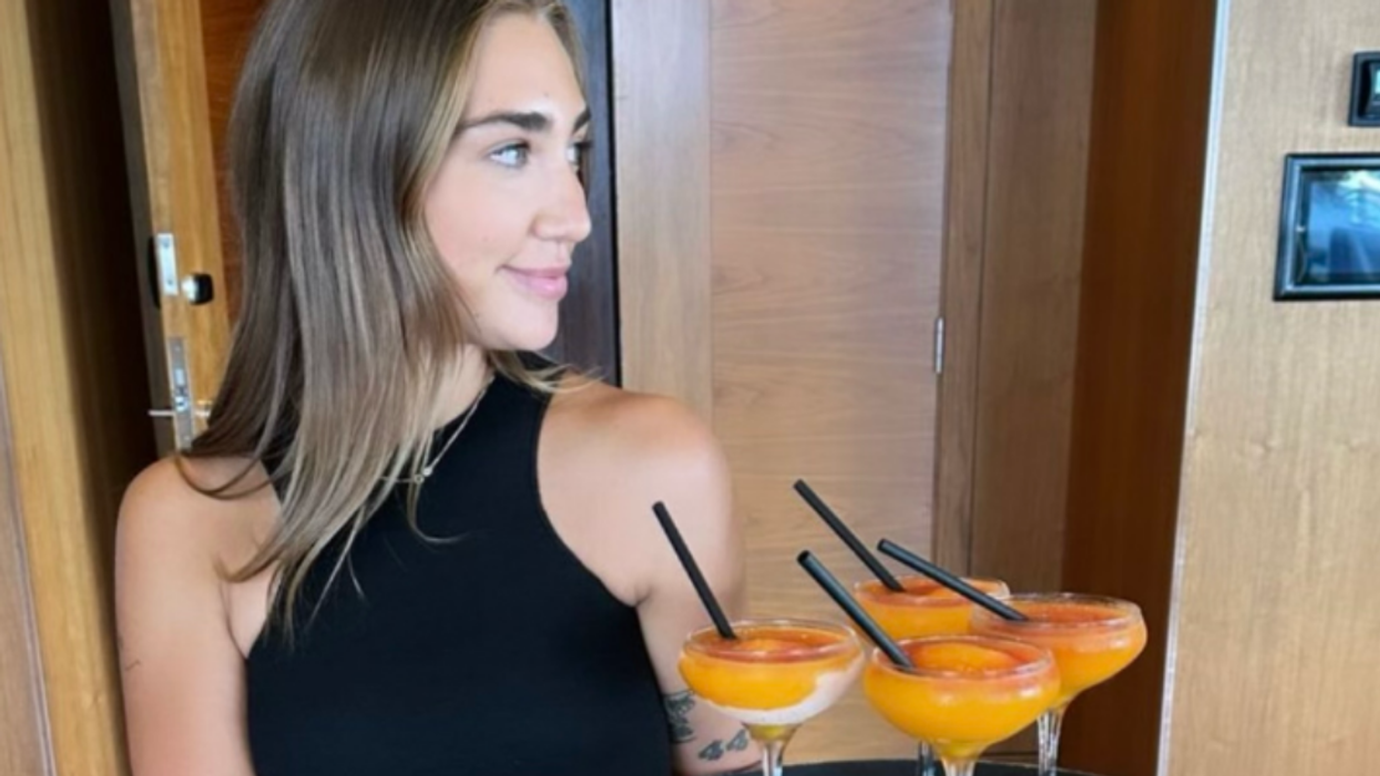 A Cactus Club Cafe server holding a tray of Bellinis.