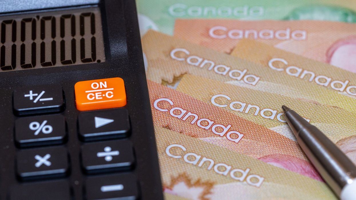 A calculator and Canadian cash (illustrative).