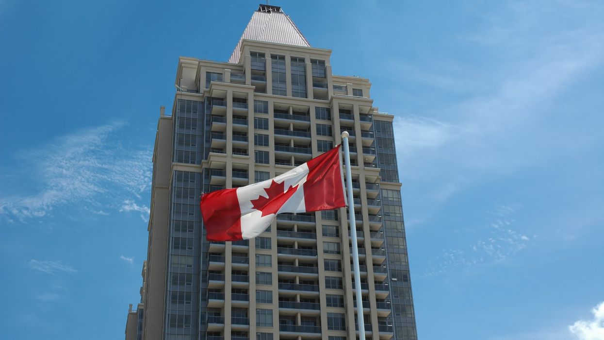 A Canadian office building, with Canada flag flying in front of it.