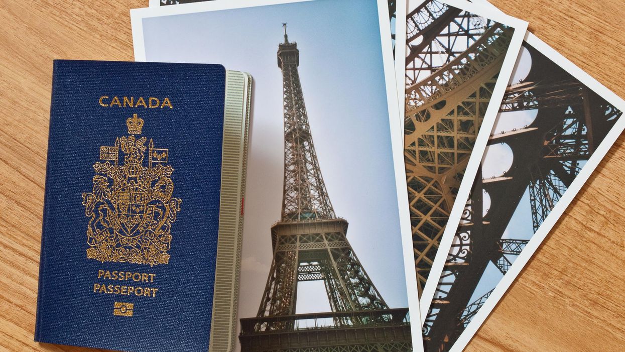 A Canadian passport placed beside photos of the Eiffel Tower.