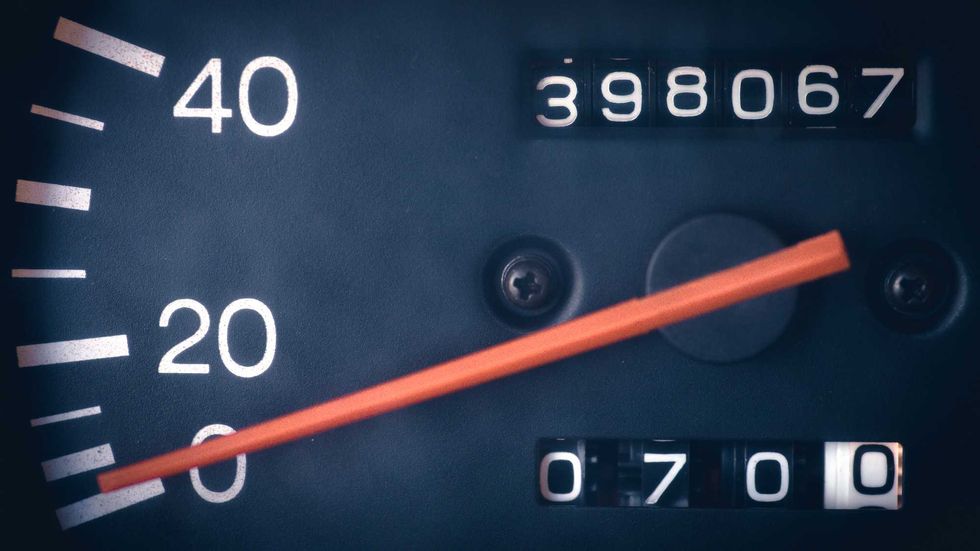 A car dashboard showing odometer reading.