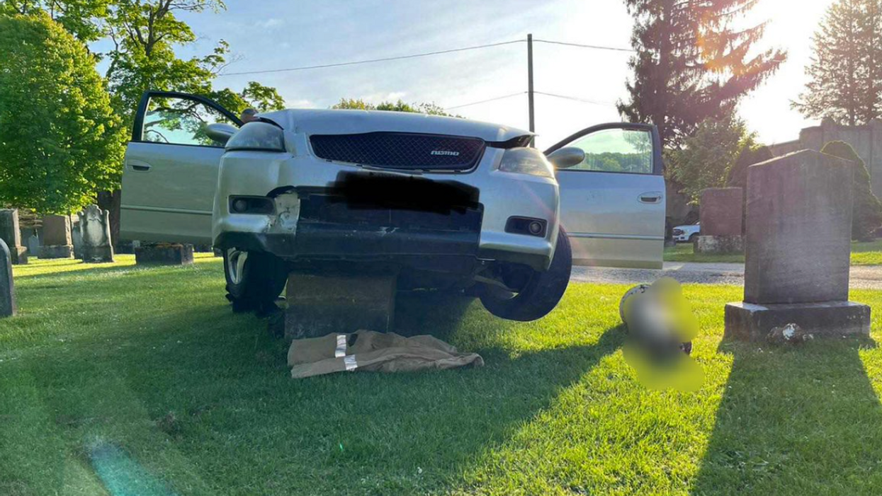 A car that got stuck on a headstone at an Ontario cemetery.