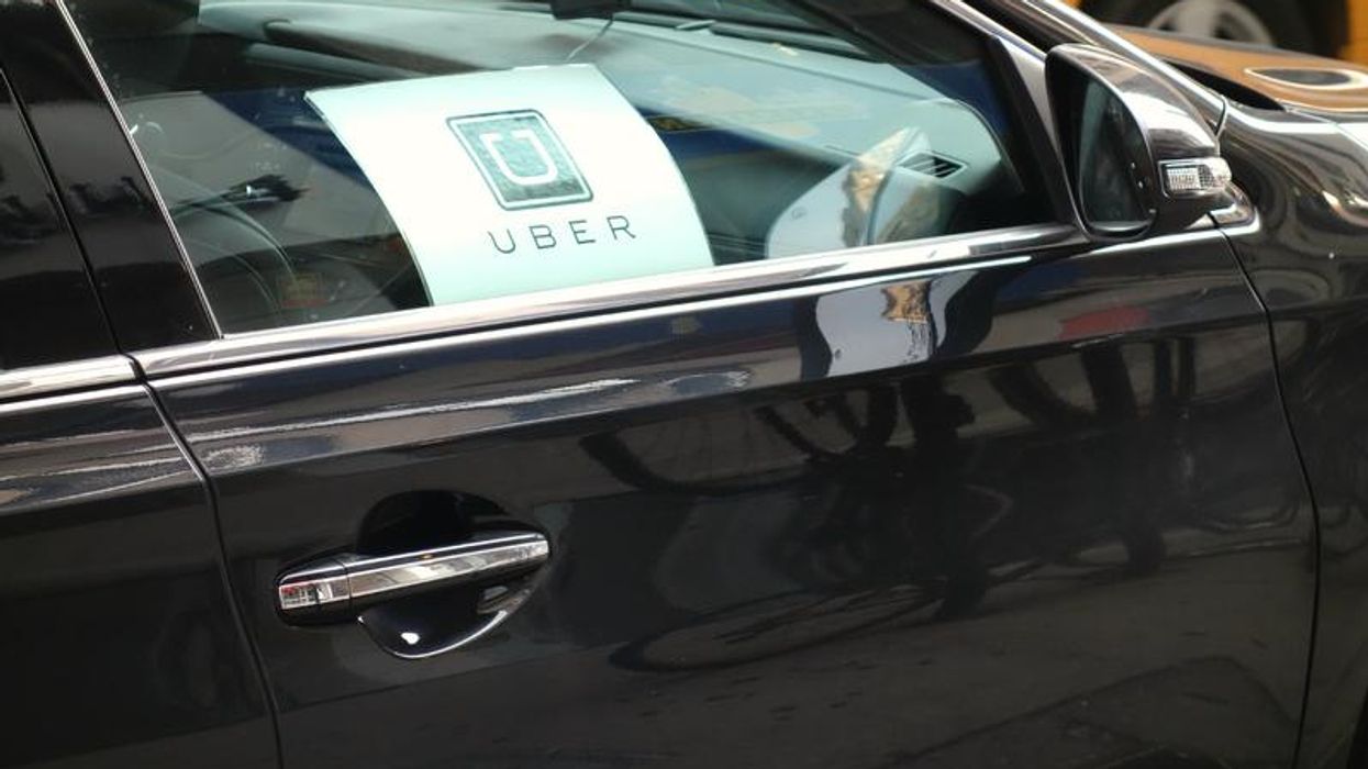 A car with an Uber sign on it.