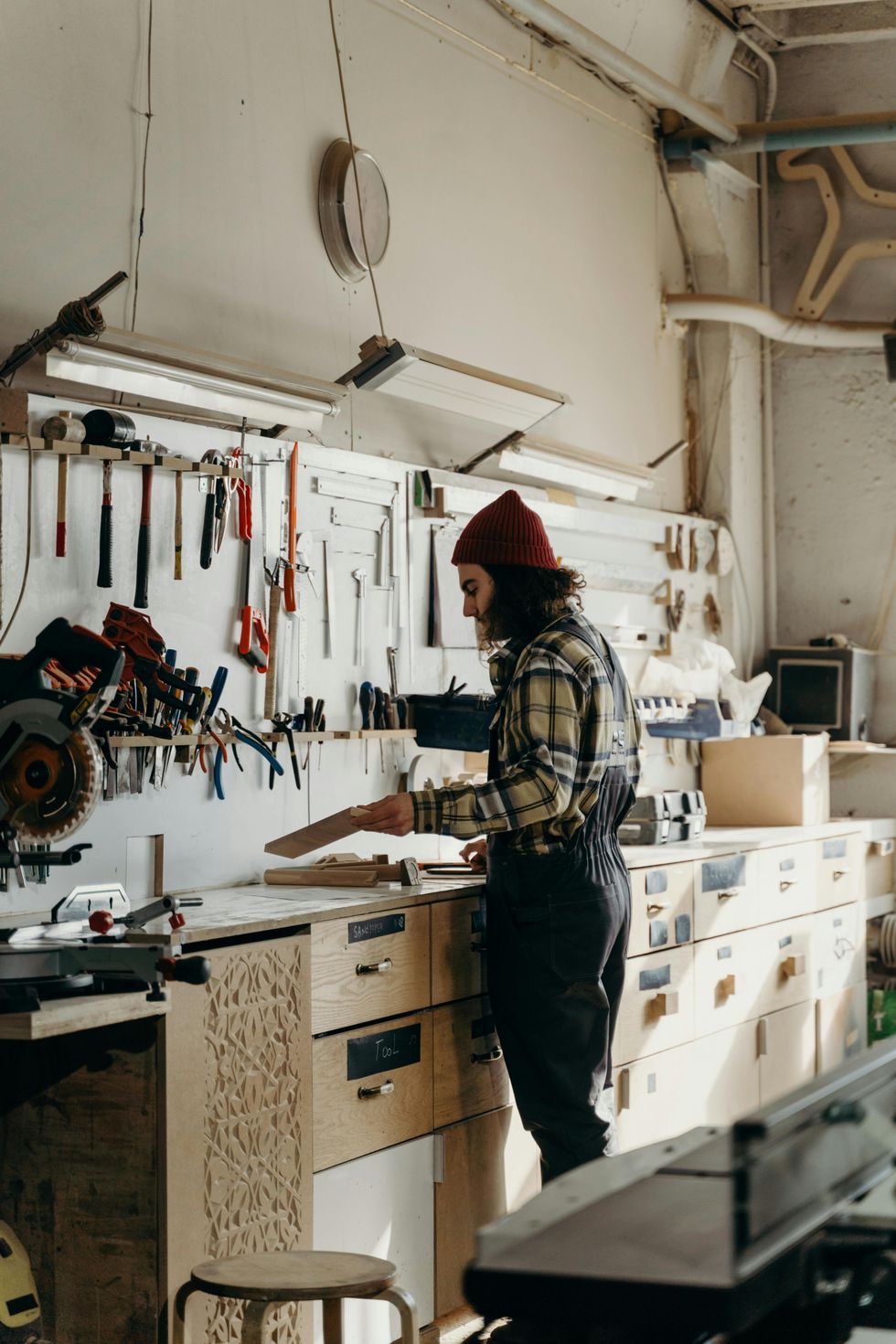 A carpenter tidying their workshop.