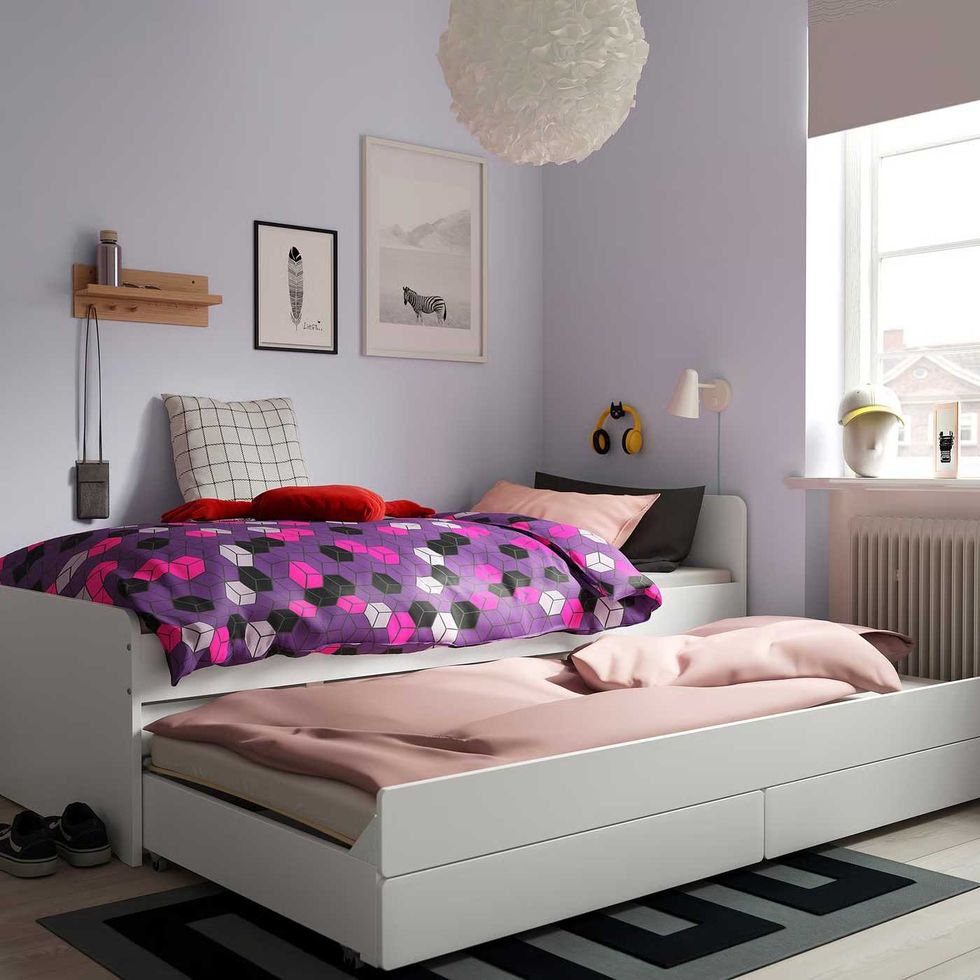 A children's bedroom with a single bed, underneath which is a single trundle mattress.