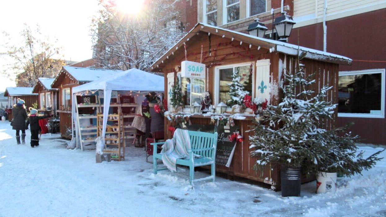 A Christmas market covered in snow.