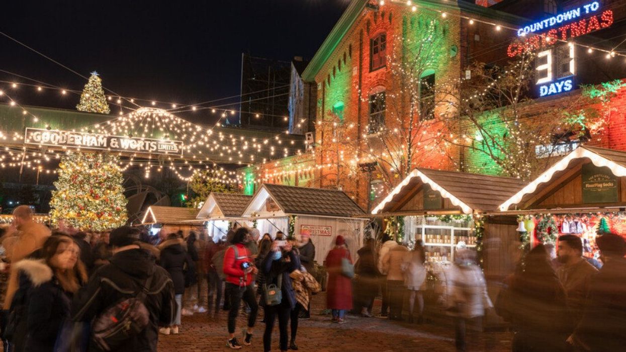 A Christmas market with cabins and lights.