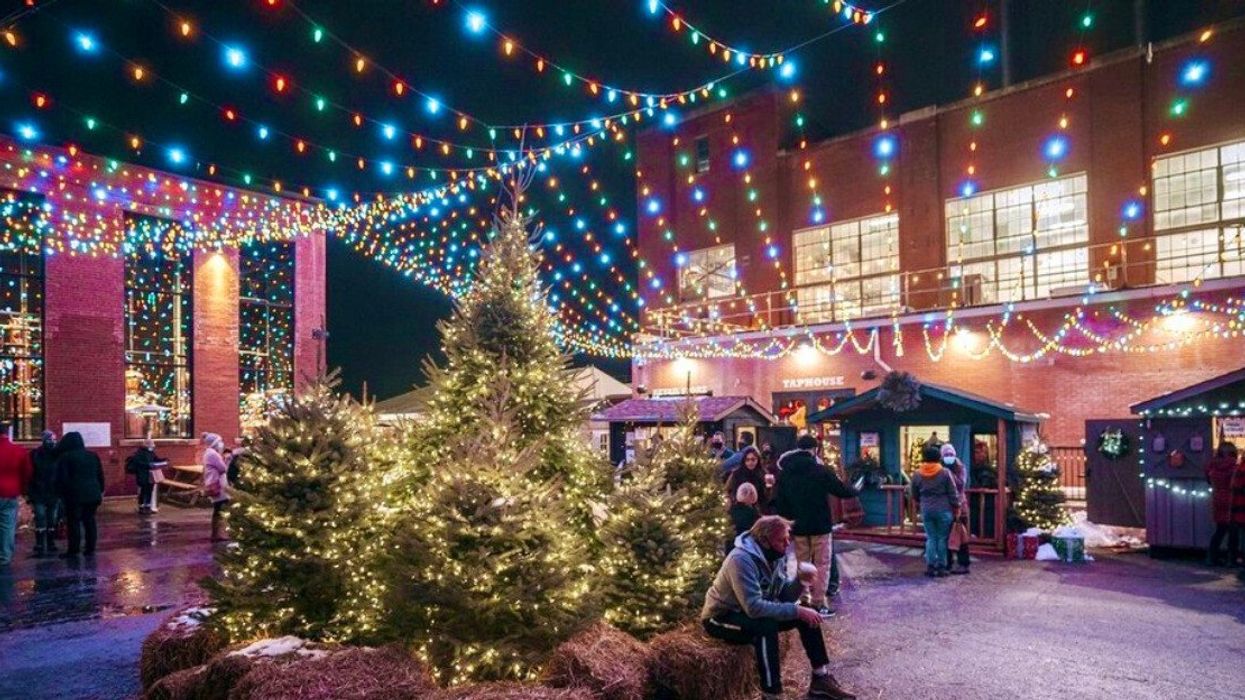 A Christmas market with trees and lights.
