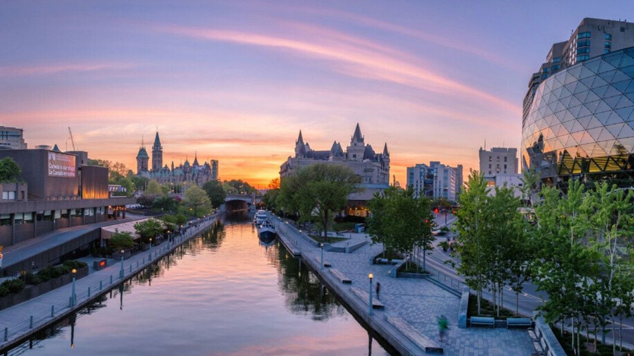 A city with a canal at sunset.