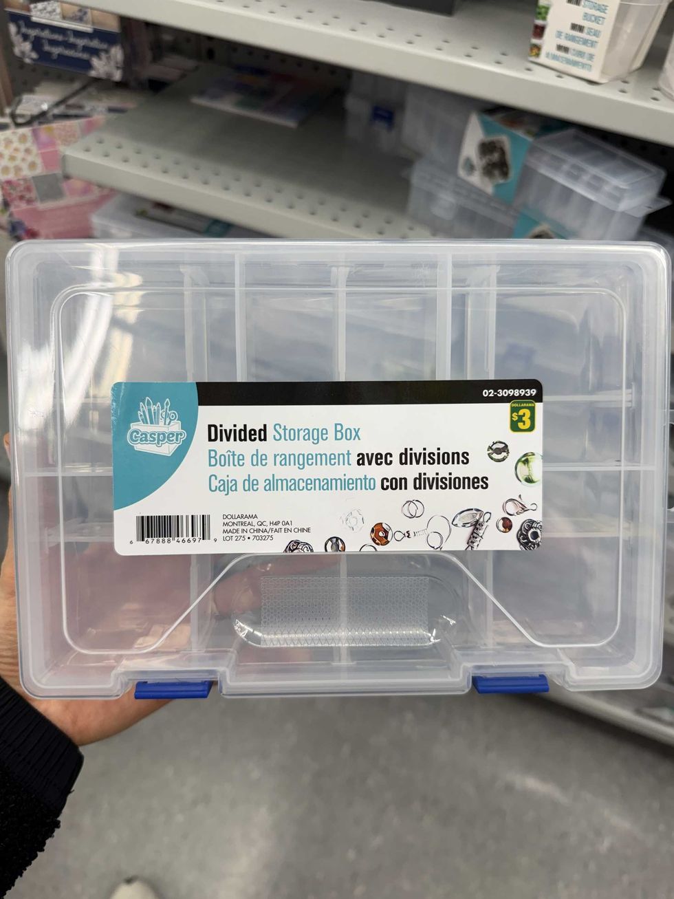 A clear box with several divided sections and a label that says divided storage box on it.