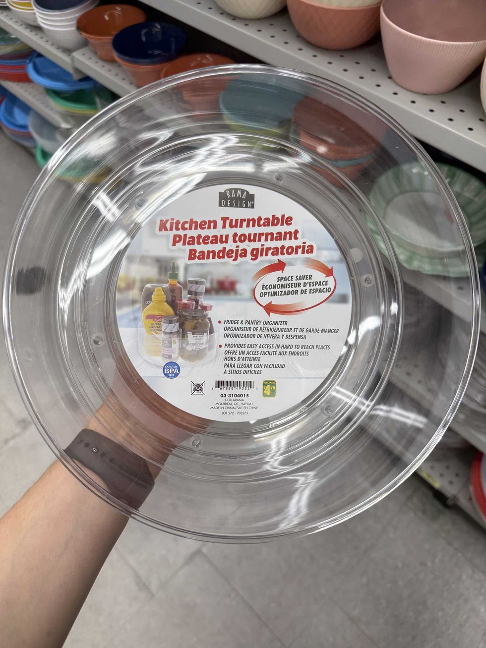 A clear plastic circular container that says kitchen turntable and has a picture of condiments on it.