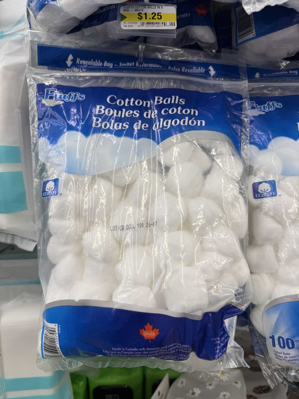 A clear, white and blue bag filled with white cotton balls.