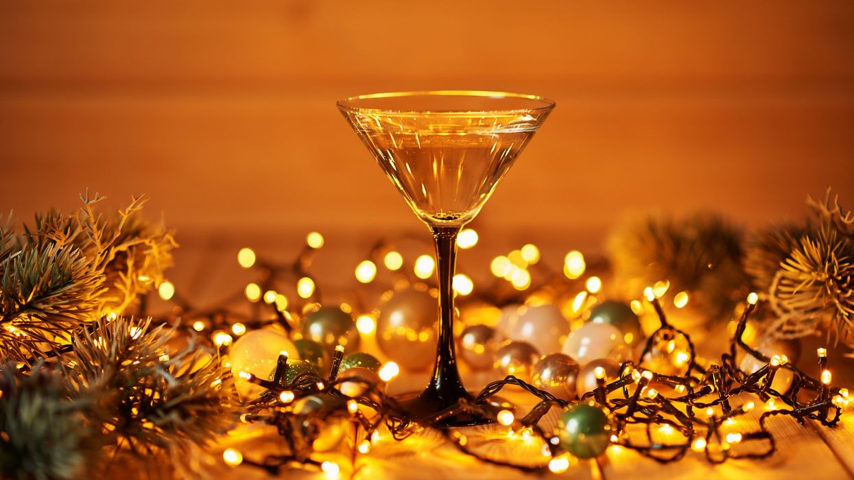 A cocktail glass surrounded by ornaments.