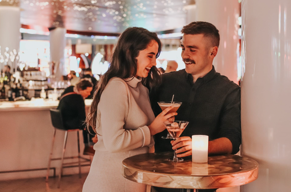 A couple drink cocktails in Bar 7.