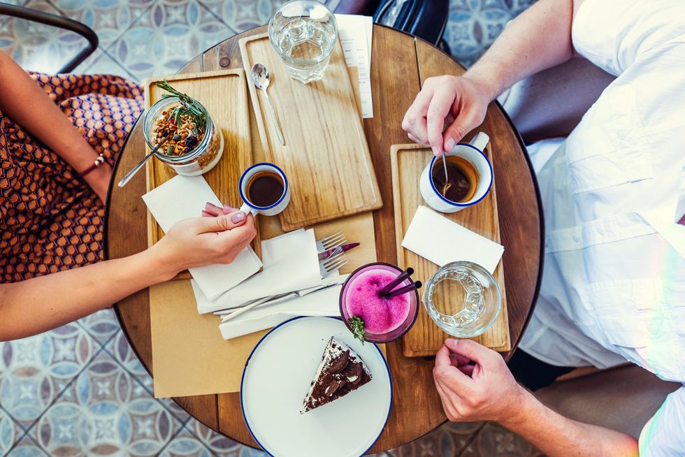 A couple eating out at a restaurant.