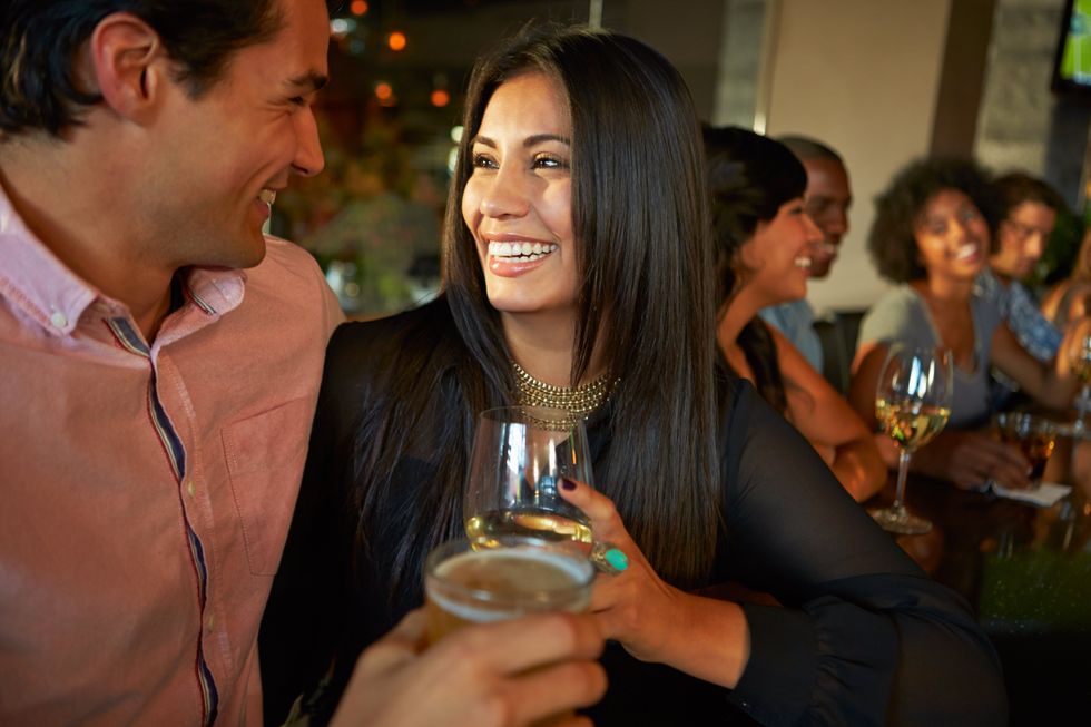 A couple enjoying drinks at the bar.
