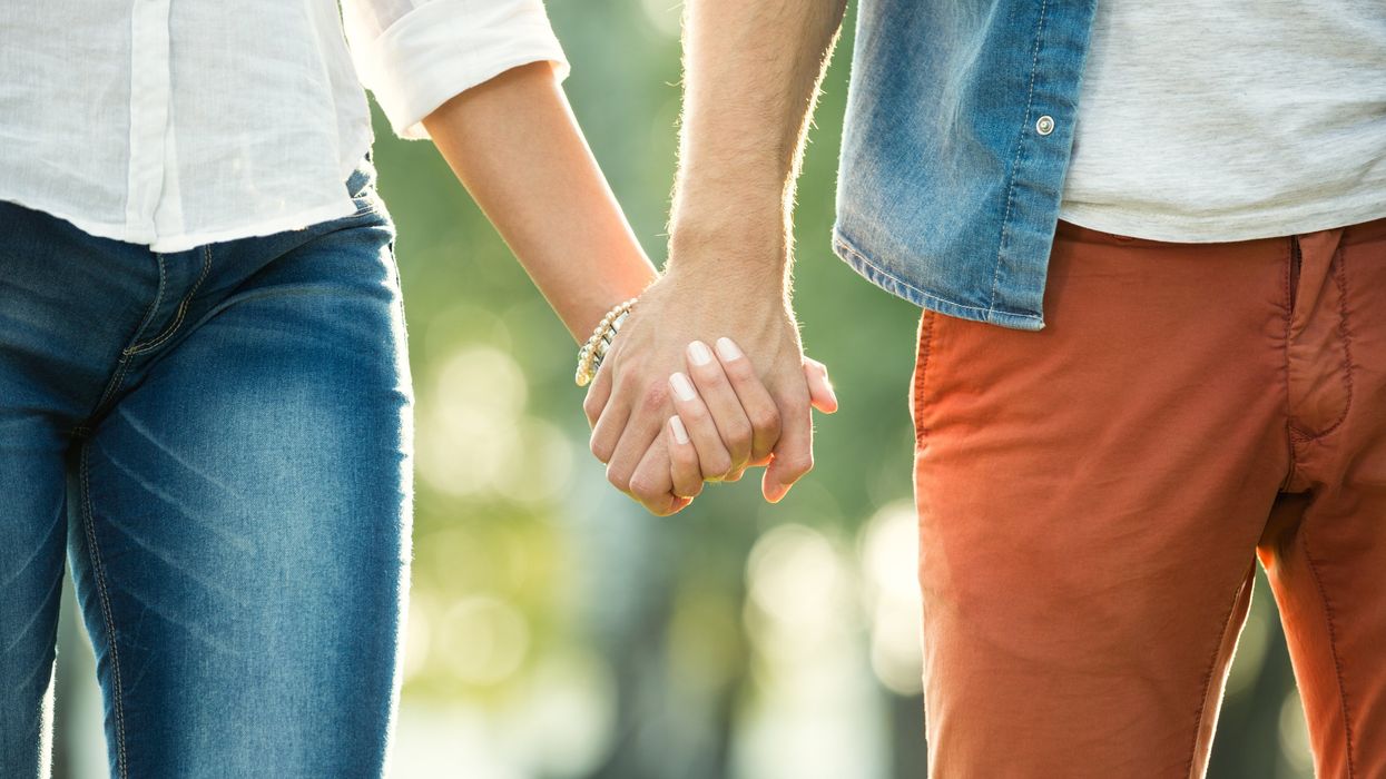 A couple holding hands.