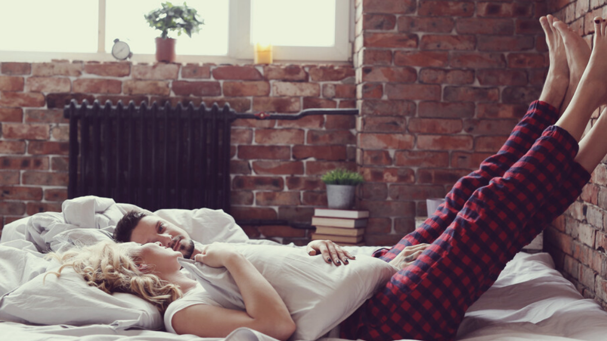 A couple laying in bed.